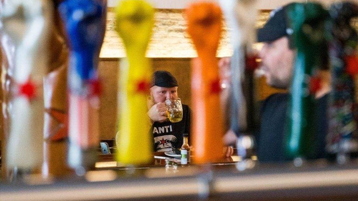 Aaron Keefner takes a sip of his beer at Revolution Brewing