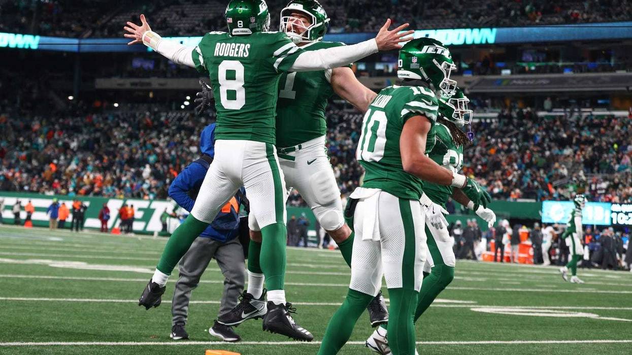 Aaron Rodgers jumping into air with teammate