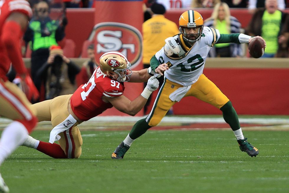 Aaron Rodgers tries to escape 49ers defender Nick Bosa