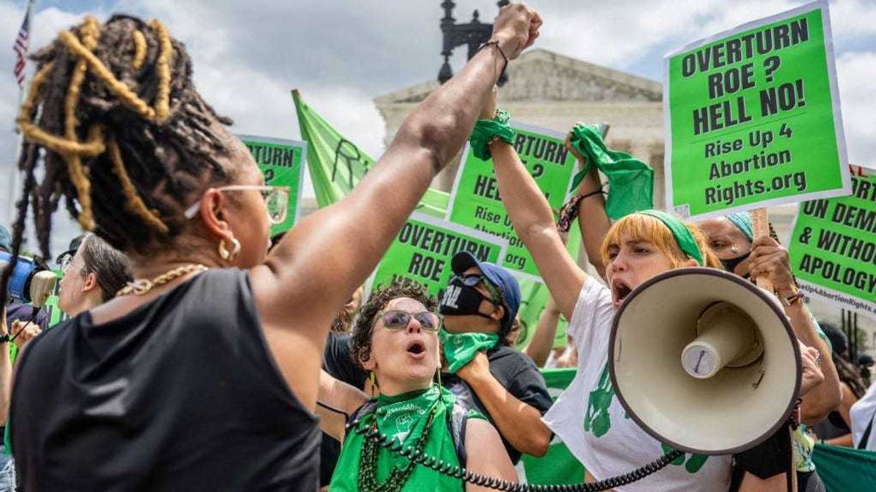 Abortion rights demonstrator Elizabeth White leads a chant in response to the Dobbs v Jackson Women's Health Organization ruling in front of the U.S. Supreme Court on June 24, 2022 in Washington, DC.