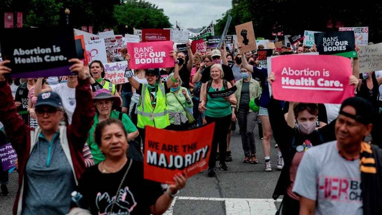 Abortion-rights demonstrators walk down Constitution Avenue during the Bans Off Our Bodies march on May 14, 2022 in Washington, DC.