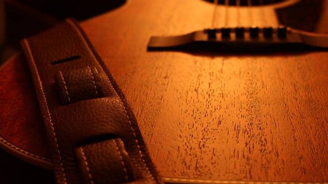 acoustic guitar with leather strap
