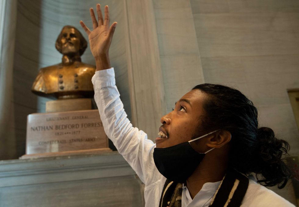 Activist Justin Jones gives praise to God in front of the Nathan Bedford Forrest bust in the State Capitol Thursday, July 22, 2021 in Nashville, Tenn., after the removal of the bust was approved by by the State Building Commission. Jones led protests over the summer of 2020 to have the bust removed. A decadeslong effort to remove the bust from the Tennessee Capitol cleared its final hurdle Thursday, with state leaders approving the final vote needed to allow the statue to be relocated to a museum.