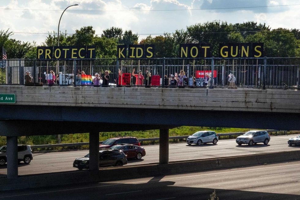 Activists across the Twin Cities have been demonstrating, including here on an overpass over Interstate 94, and calling for tougher gun laws following the shooting last week at Annunciation Catholic Church in Minneapolis.