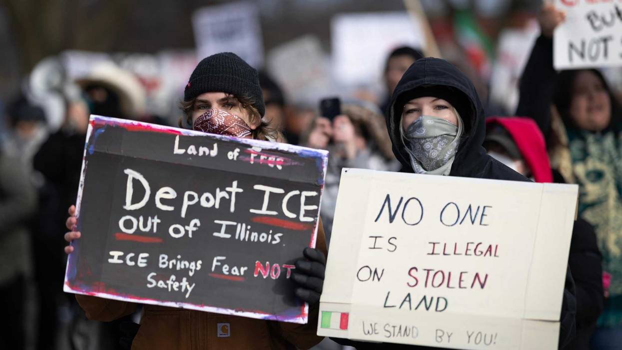 Activists march through a neighborhood protesting a recent increase of activity in the area by by Immigration and Customs Enforcement (ICE) agents on Feb. 01, 2025 in Waukegan, Illinois.