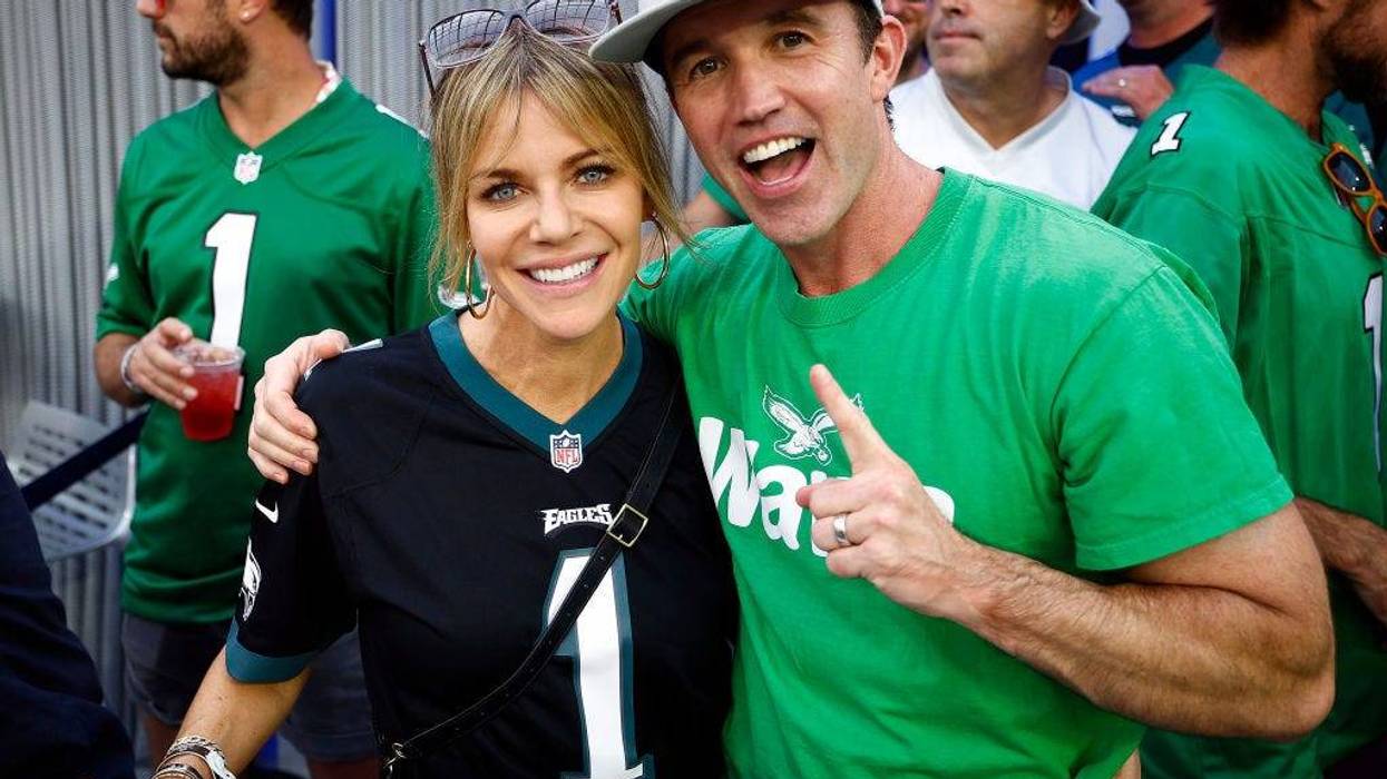 Actors Kaitlin Olson and Rob McElhenney pose for photos during the game between the Philadelphia Eagles and the Los Angeles Rams at SoFi Stadium on October 08, 2023 in Inglewood, California. (Photo by Ronald Martinez/Getty Images)