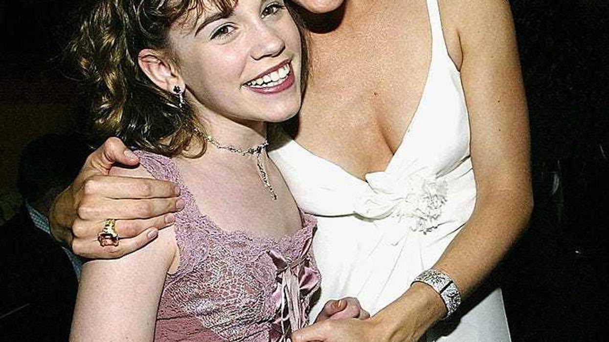 Actress Christa Allen (L) and actress Jennifer Garner hug at the after party for the film "13 going on 30" following the premiere of the film April 14, 2004 in Westwood, California. (Photo by Carlo Allegri/Getty Images)