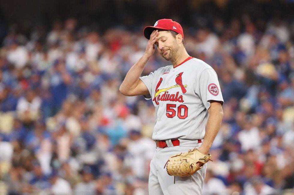 Adam Wainwright #50 of the St. Louis Cardinals reacts after walking Cody Bellinger #35 of the Los Angeles Dodgers in the third inning.