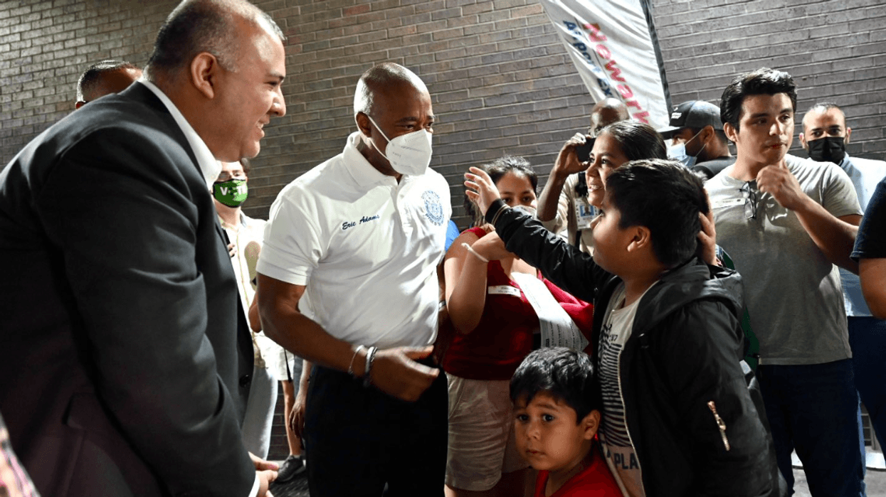 Adams greets a group of children seeking asylum in the U.S. who arrived in New York City on Sunday.