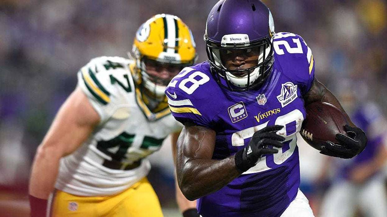 Adrian Peterson #28 of the Minnesota Vikings carries the ball as defender Jake Ryan #47 of the Green Bay Packers pursues him during their game on September 18, 2016 at US Bank Stadium in Minneapolis, Minnesota.