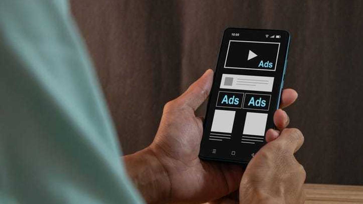 Advertising media on smartphone. Digital marketing strategy concept. Man seeing an advertisement on social media on his smartphone.