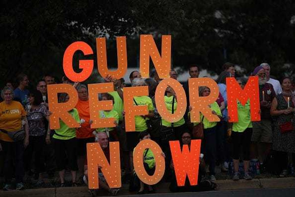 Advocates of gun reform legislation hold a candle light vigil for victims of recent mass shootings outside the headquarters of the National Rifle Association August 5, 2019 in Fairfax, Virginia.