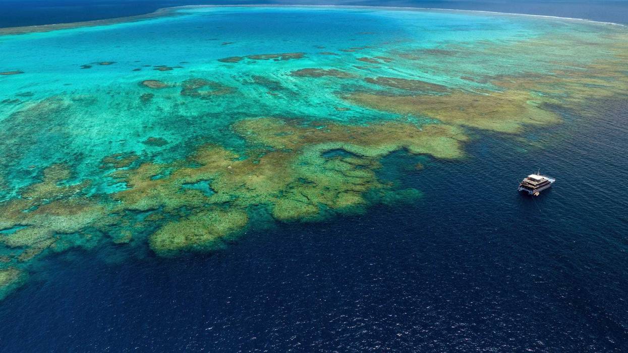 Aerial photograph of a boat at the Bougainville Reef in Coral Sea