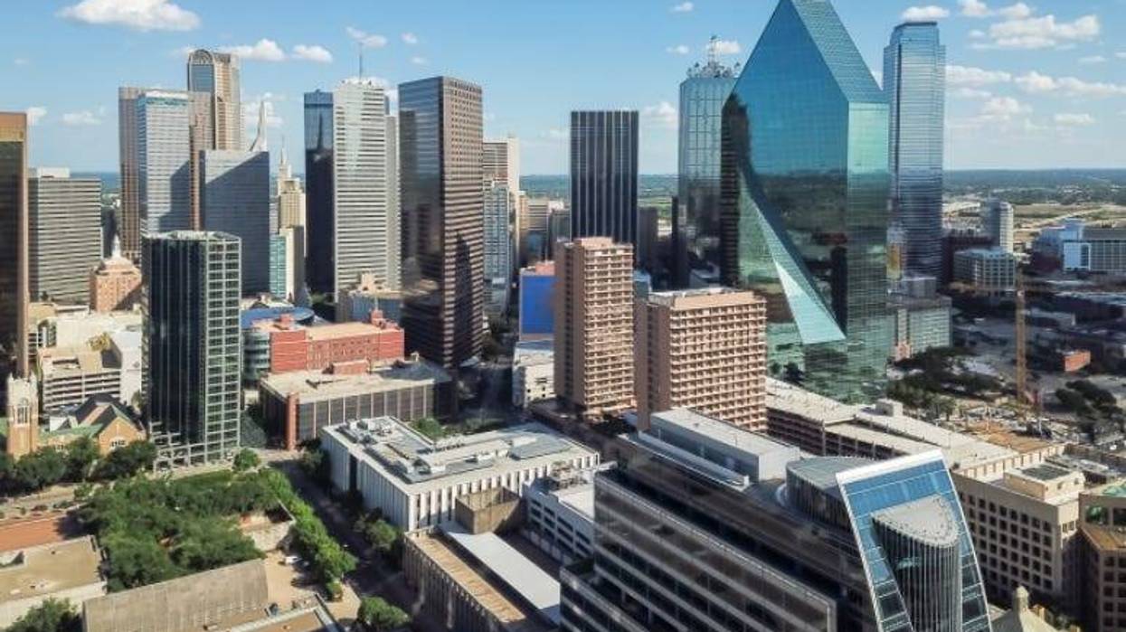 Aerial view Downtown Dallas skyscrapers under cloud blue sky. Midtown, freeway