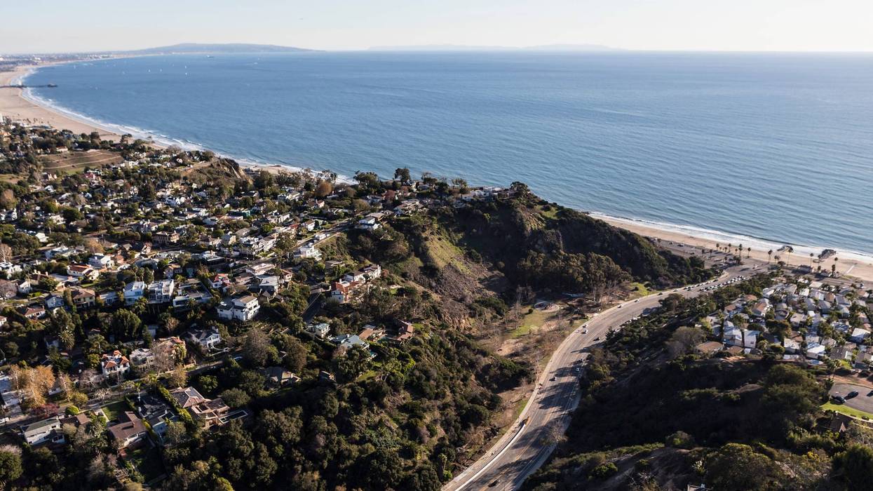Aerial view of Temescal Canyon Road, Pacific Palisades homes and Santa Monica Bay in Los Angeles, California.