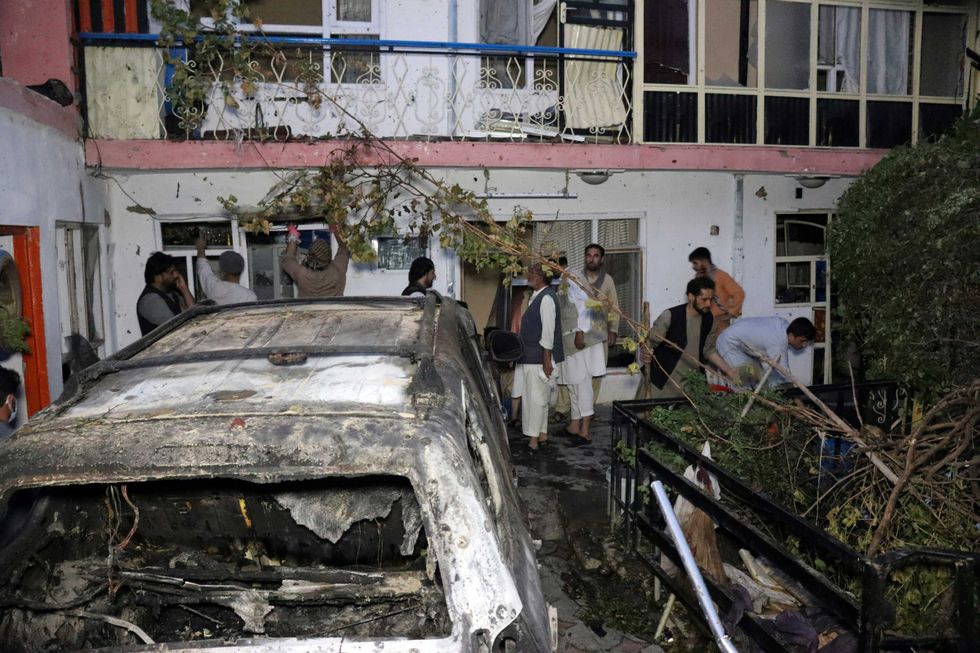 Afghan people are seen inside a house after U.S. drone strike in Kabul, Afghanistan, Sunday, Aug. 29, 2021. A U.S. drone strike destroyed a vehicle carrying "multiple suicide bombers" from Afghanistan
