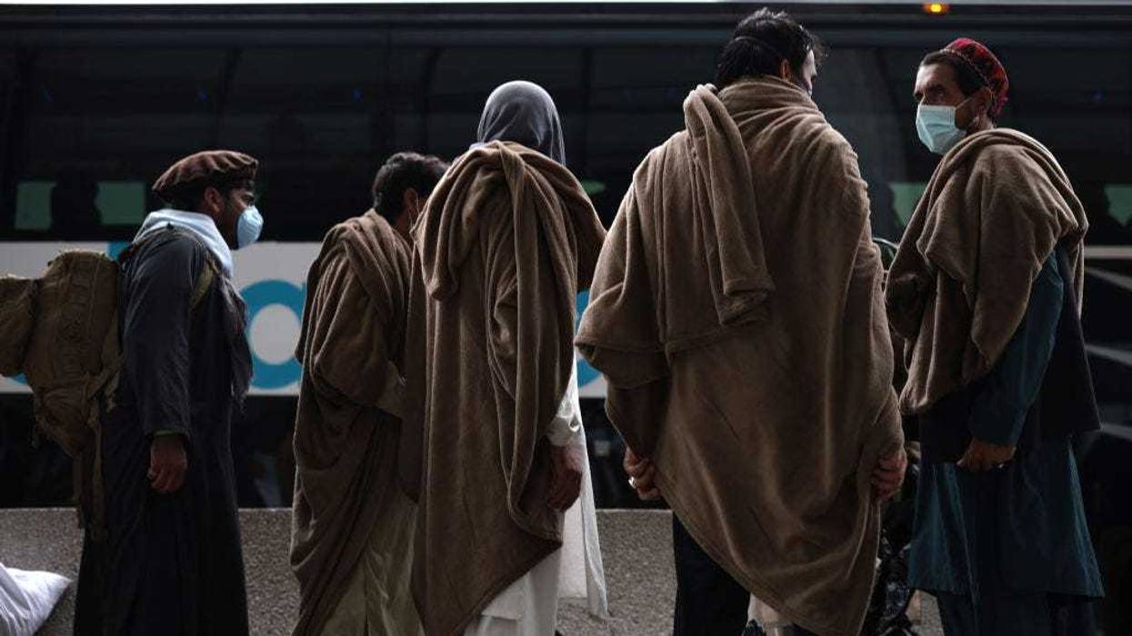 Afghan refugees board a bus at Dulles International Airport.