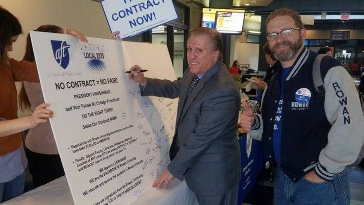 AFT local 2373 President Dr. Joseph Basso and Vice President Gerald Hough sign a petition board at Rowan University.