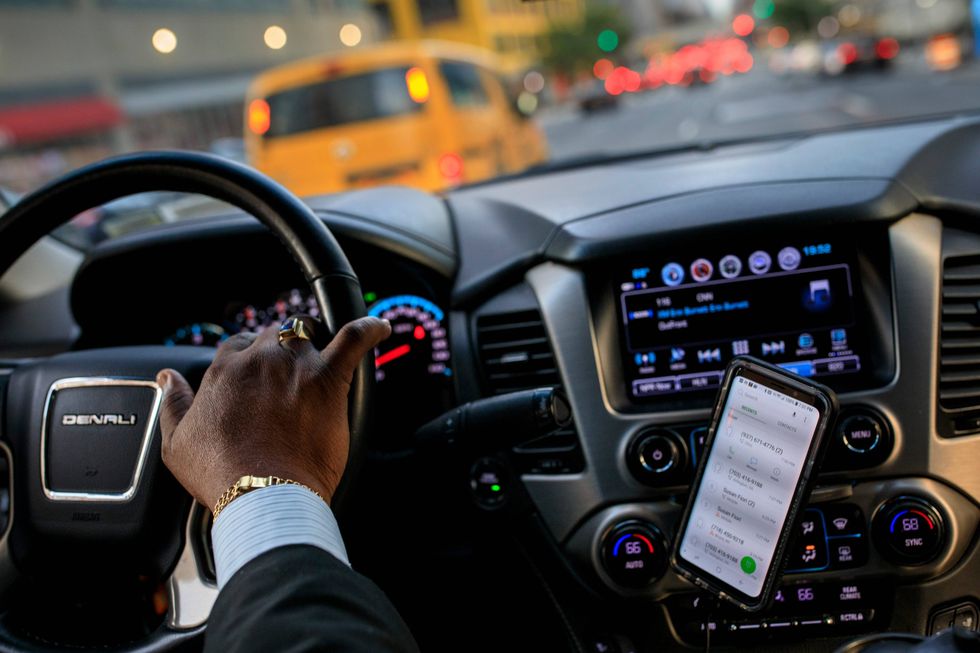 After dropping off passengers at a Broadway play, Johan Nijman, a for-hire driver who runs his own service and also drives for Uber on the side, drives through the West Side of Manhattan on Wednesday evening, August 8, 2018 in New York City.