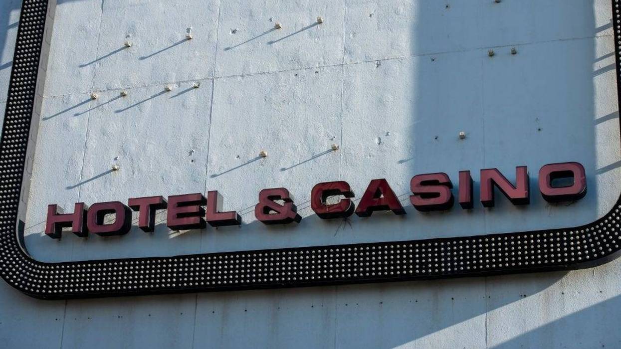Afternoon light illuminates a sign stating 'HOTEL & CASINO' remaining on the exterior facade of Trump Plaza Hotel & Casino