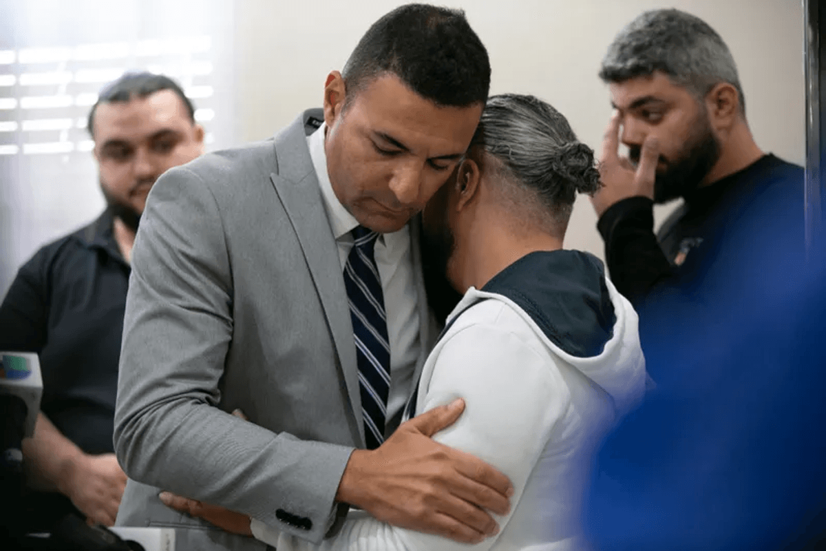 Ahmed Rehab, left, executive director of the Chicago chapter of the Council on American-Islamic Relations, embraces Odey Al-Fayoume, father of Wadea Al-Fayoume, 6, at a news conference at the Muslim Community Center on Chicago's Northwest Side, Sunday, Oct. 15, 2023.