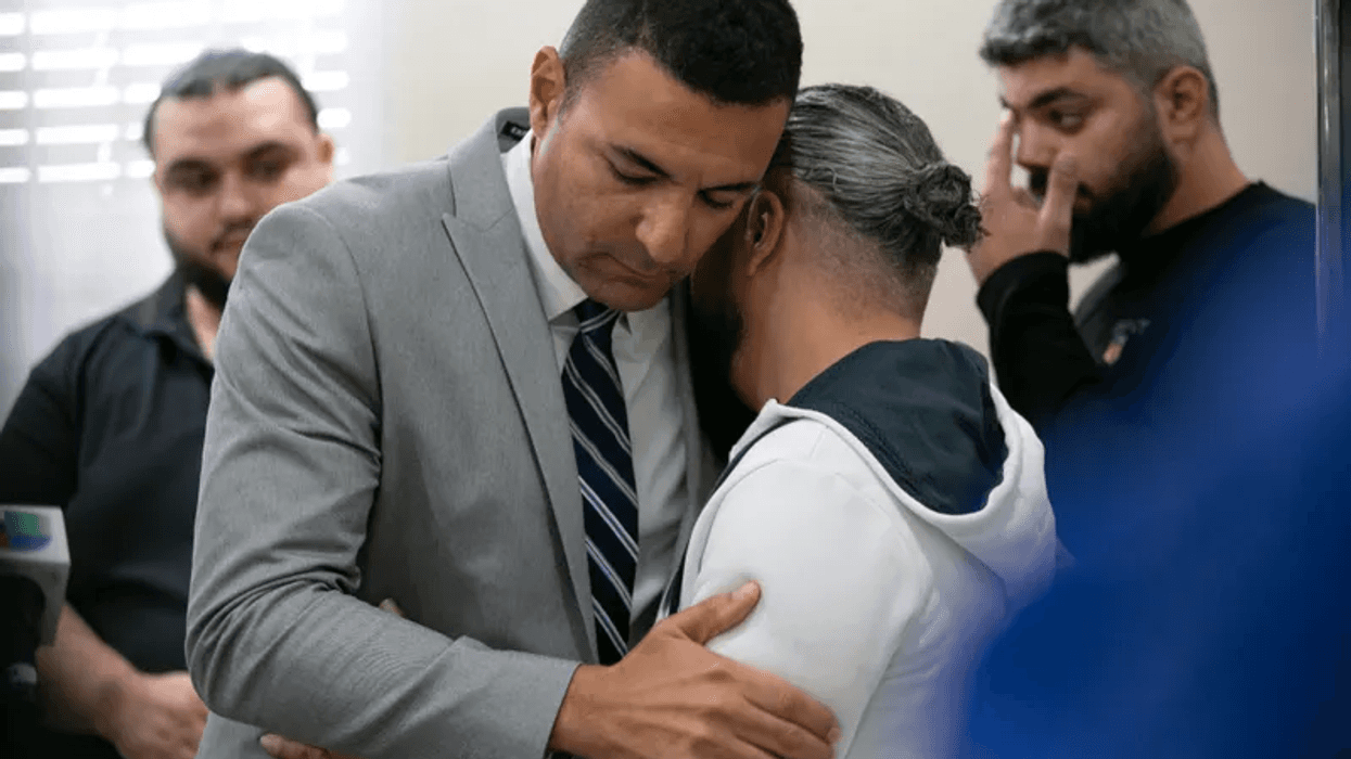 Ahmed Rehab, left, executive director of the Chicago chapter of the Council on American-Islamic Relations, embraces Odey Al-Fayoume, father of Wadea Al-Fayoume, 6, at a news conference at the Muslim Community Center on Chicago's Northwest Side, Sunday, Oct. 15, 2023.