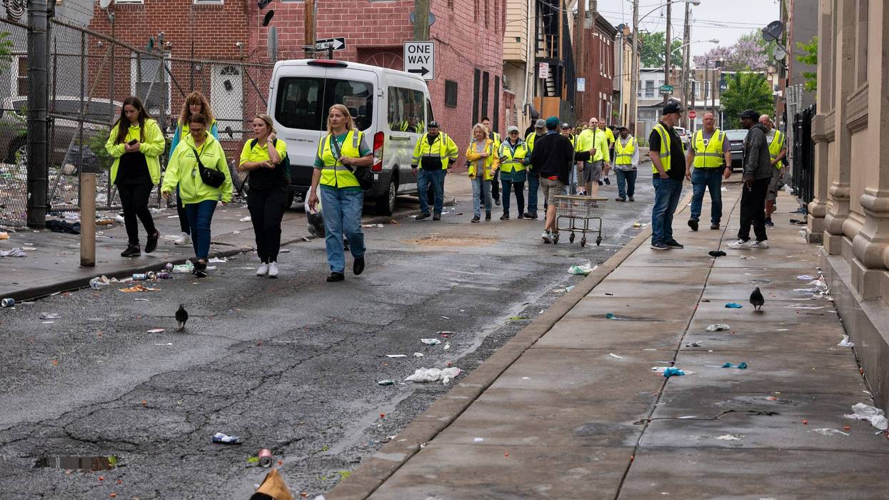 Aid workers walk down a side street in Kensington on May 8, 2024, the day the city cleared out encampments along Kensington Avenue.