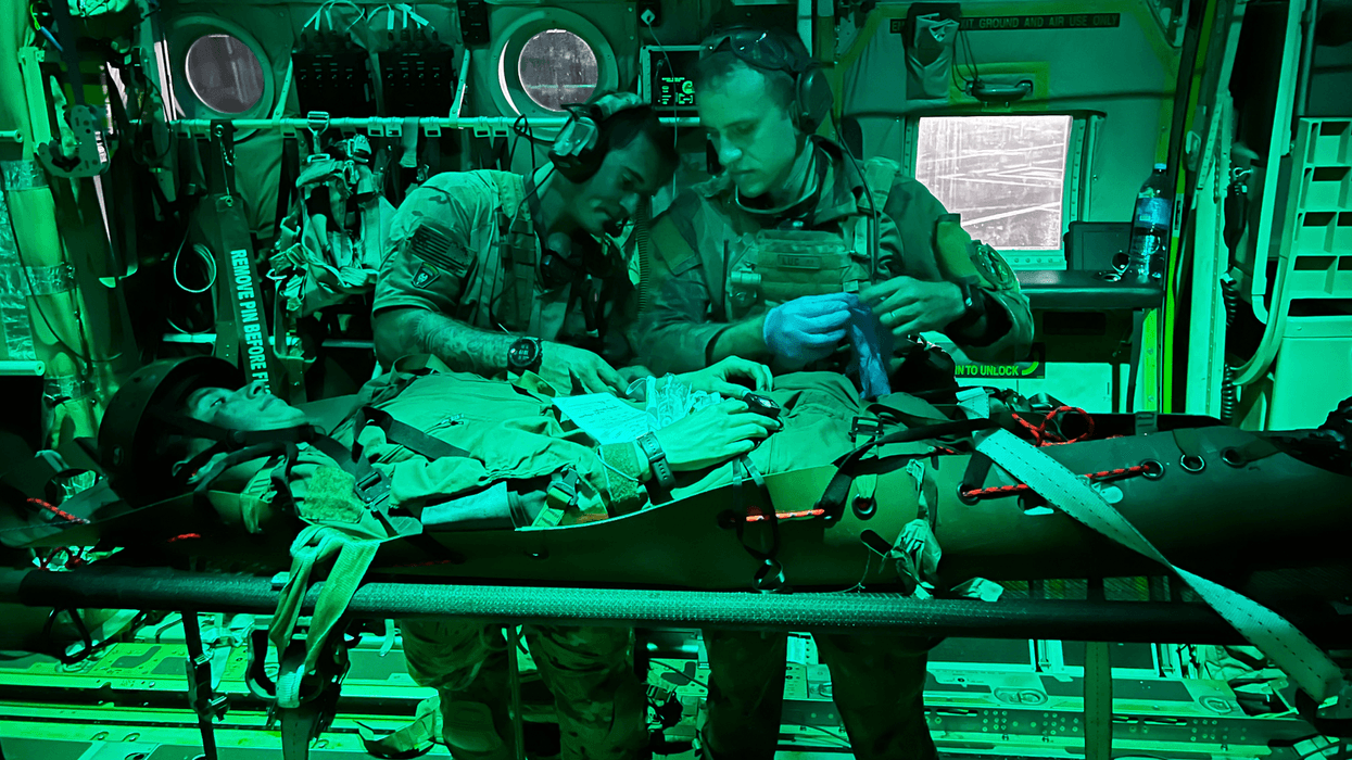 Air Force Senior Airman Matt Pluhoeski, right, works with a Brazilian service member during a simulated medical evacuation as part of Exercise Tapio in Campo Grande, Brazil, Aug. 24, 2022. Pluhoeski is a pararescue airman assigned to the 103rd Rescue Squadron of the New York Air National Guard’s 106th Rescue Squadron.