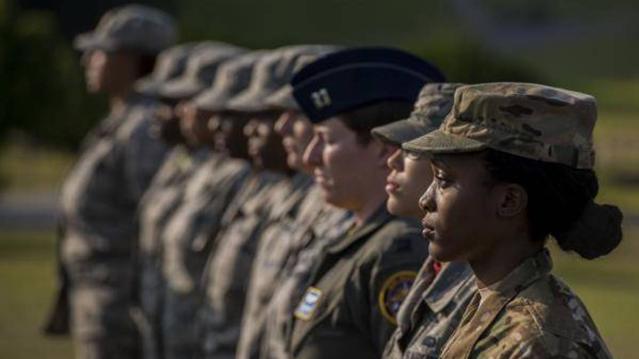Air Force women at Kadena Air Base stand at attention during womens history month ceremony