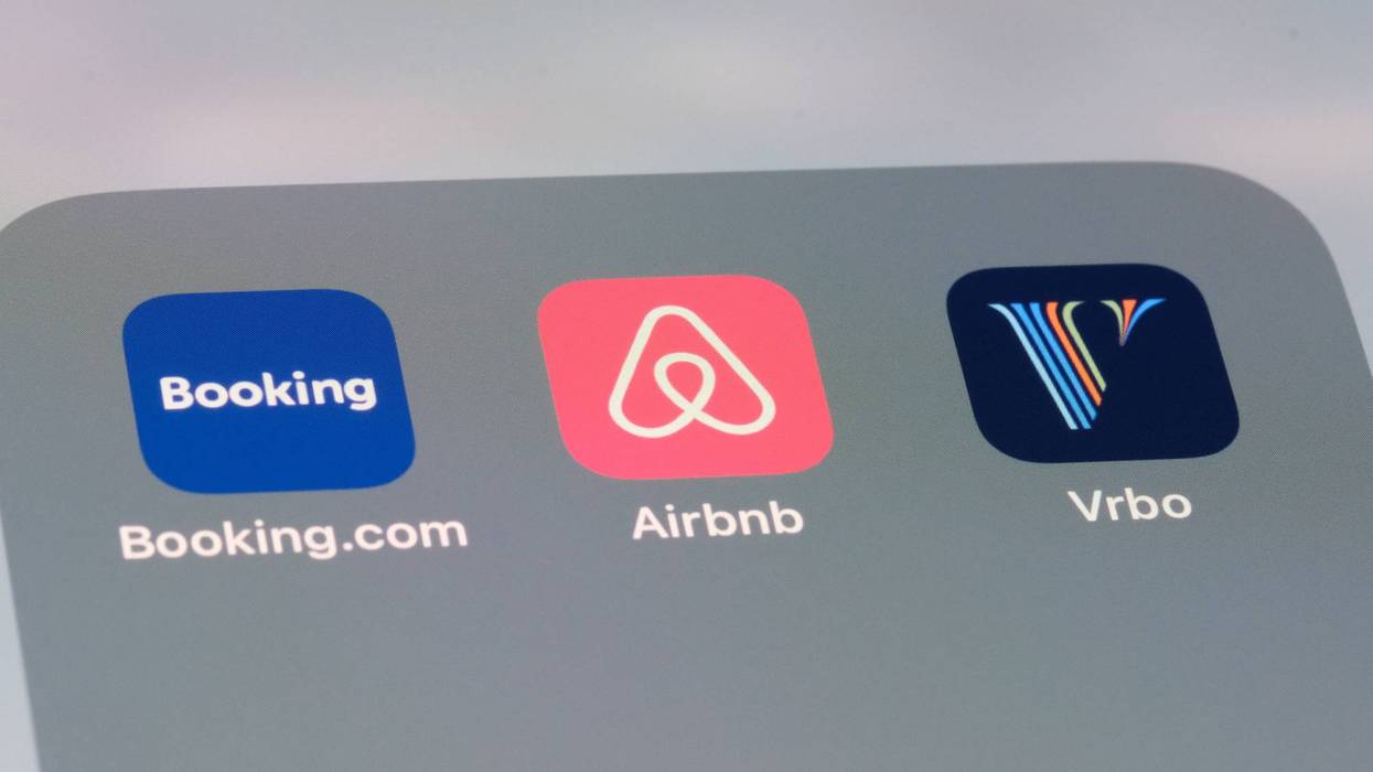 Airbnb, Booking.com and Vrbo apps. Assorted online rental brands