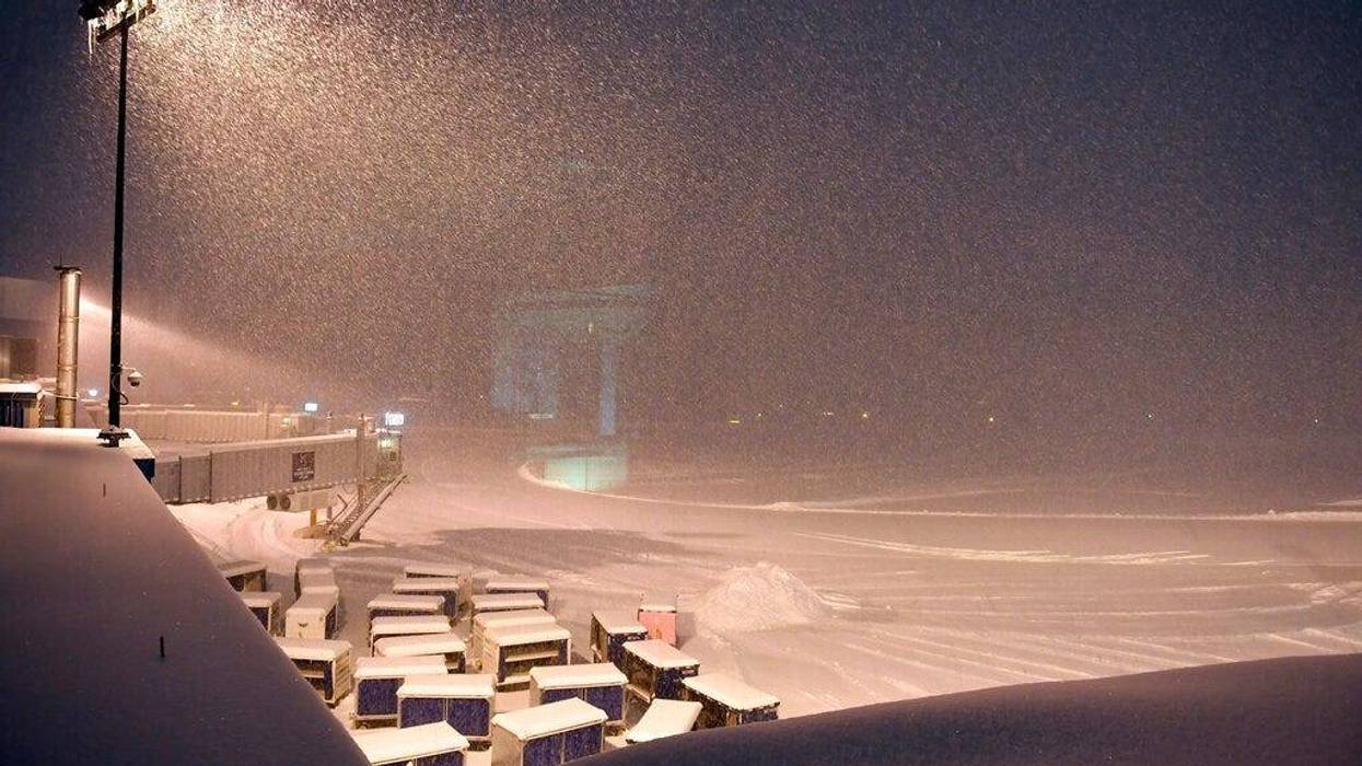 Airline baggage carts sit on the tarmac as crews prepare to remove snow at the Albany International Airport in Colonie, N.Y., Sunday, Jan. 20, 2019