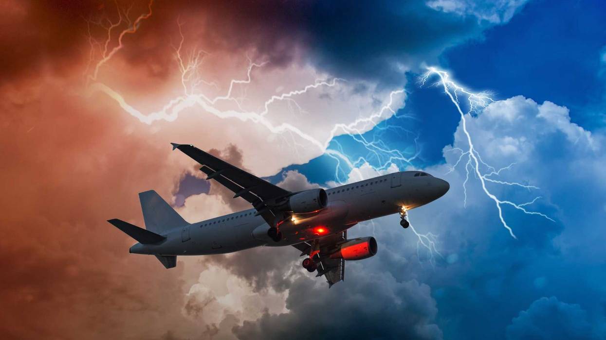 airplane flies in bad weather and storm with lightning bolt