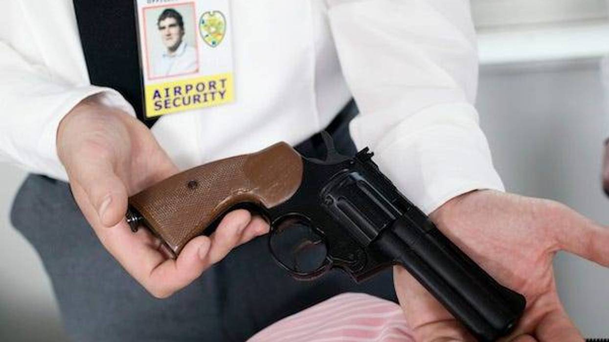 Airport security holding a handgun