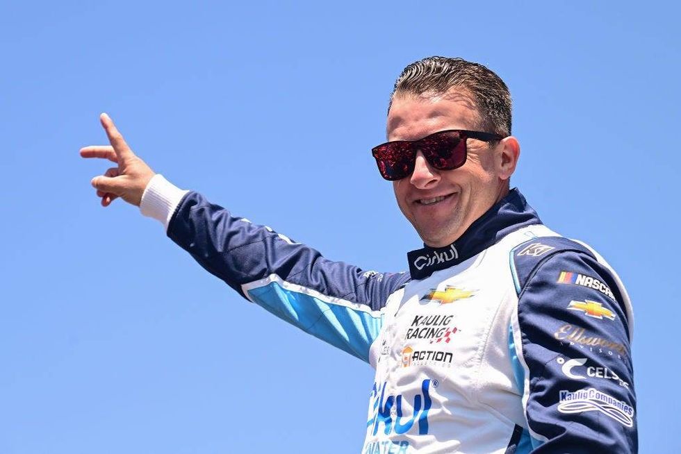 AJ Allmendinger, driver of the #16 Cirkul Chevrolet, waves to fans as he walks onstage during driver intros prior to the NASCAR Cup Series Toyota/Save Mart 350 at Sonoma Raceway on June 09, 2024 in Sonoma, California.