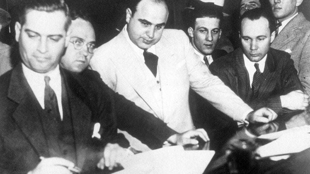 Al Capone (1899 - 1947) signing Uncle Sam's $50,000 bail bond in the Federal Building, Chicago.