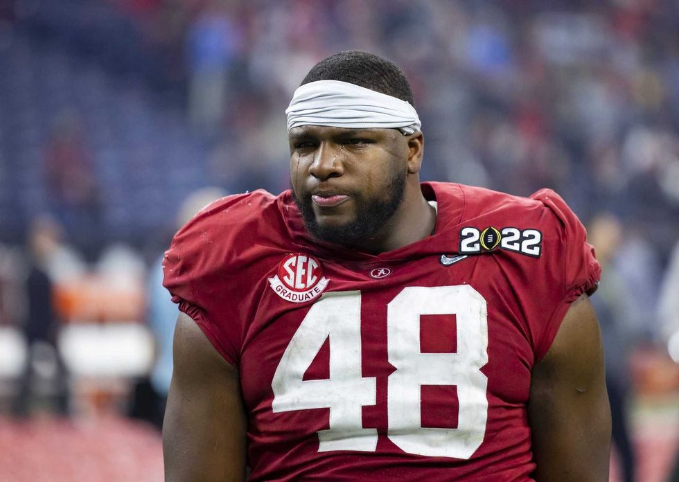 Alabama Crimson Tide defensive lineman Phidarian Mathis (48) reacts as he walks off the field after losing to the Georgia Bulldogs in the 2022 CFP college football national championship game at Lucas Oil Stadium.