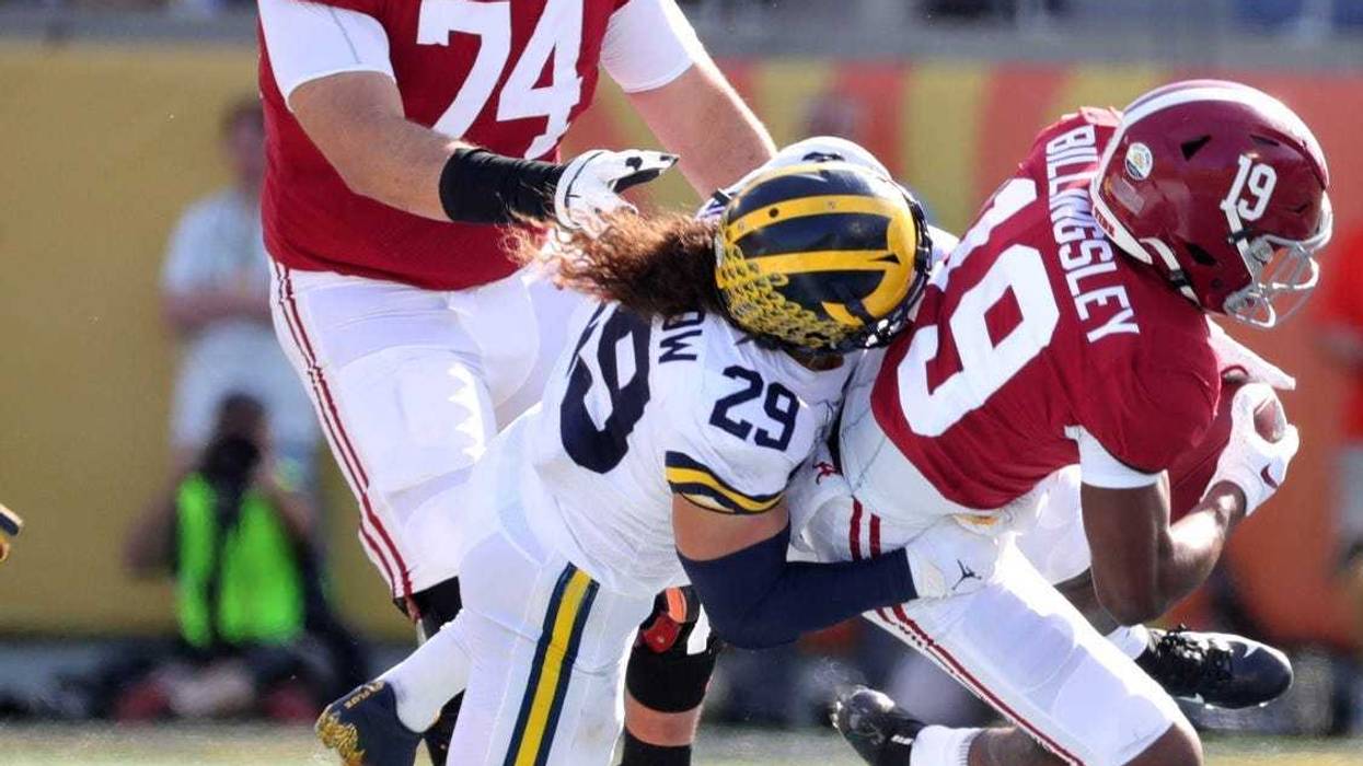 Alabama's Jedrick Wills Jr. (74) watches as Michigan's Jordan Glasgow tackles Alabama's Jahleel Billingsley during the Citrus Bowl, Jan. 1, 2020 in Orlando, Fla.