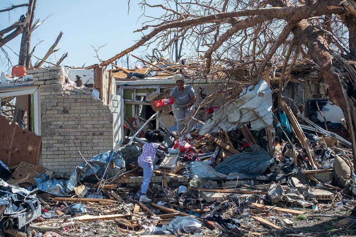 Alaina Dean, 8, and her mother Shannekia Miles salvage what they can from their home on 7th Street in Rolling Fork, Miss., Saturday, March 23, 2023, after a tornado cut through the small Delta town Friday night. They lived in the home with Miles' parents. Only her father was home when the tornado hit. He made it out alive. Tcl Rolling Fork