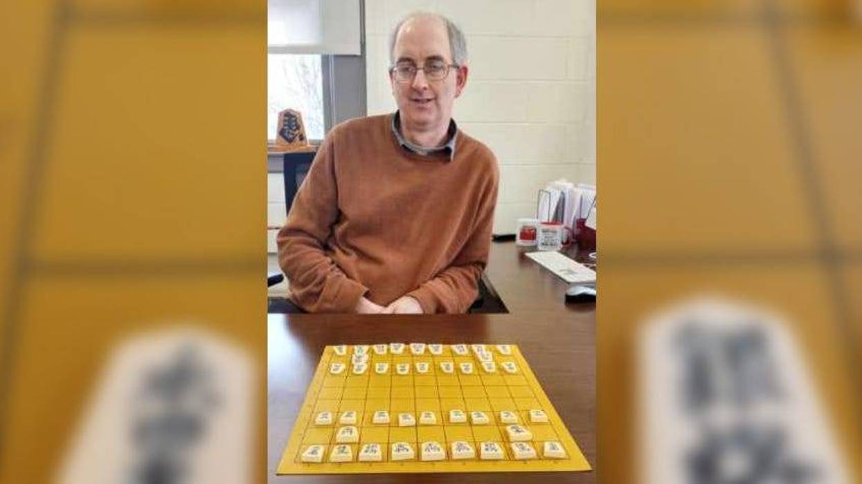 Alan Baker sits at a shogi board.