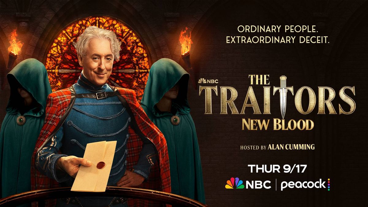 Alan Cumming smiles, holding a sealed letter, flanked by two hooded figures for The Traitors: New Blood.