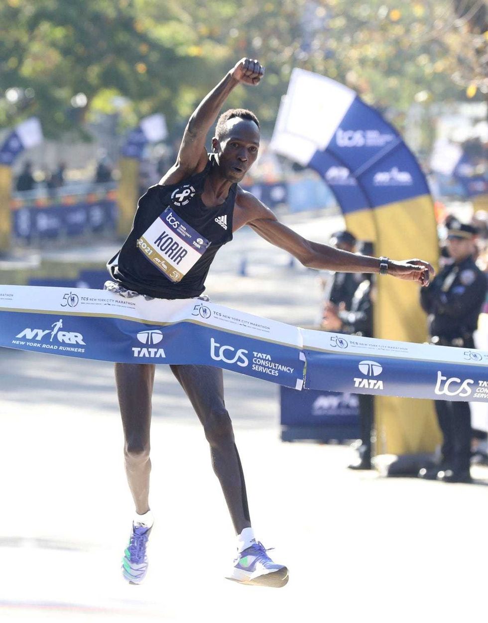 Albert Korir of Kenya leaps across the finish line as he wins the men