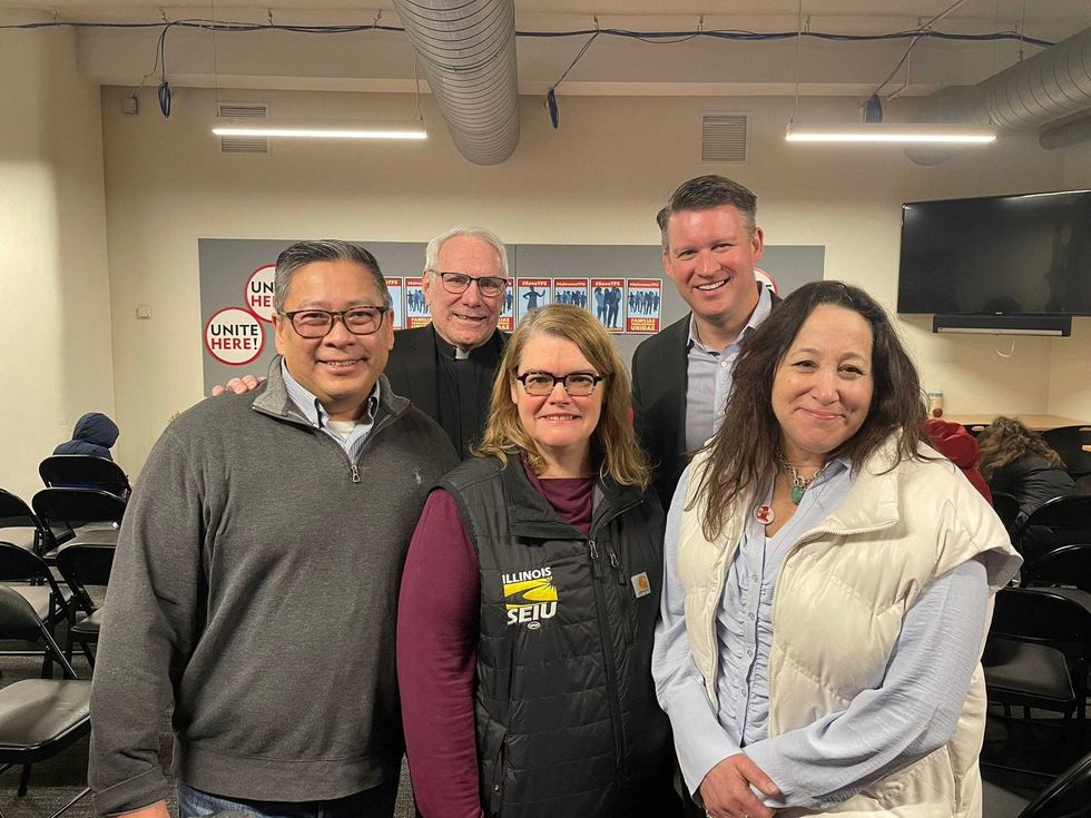 Ald. Bill Conway (second row, right), was among those at a free legal aid clinic for migrants on Saturday.