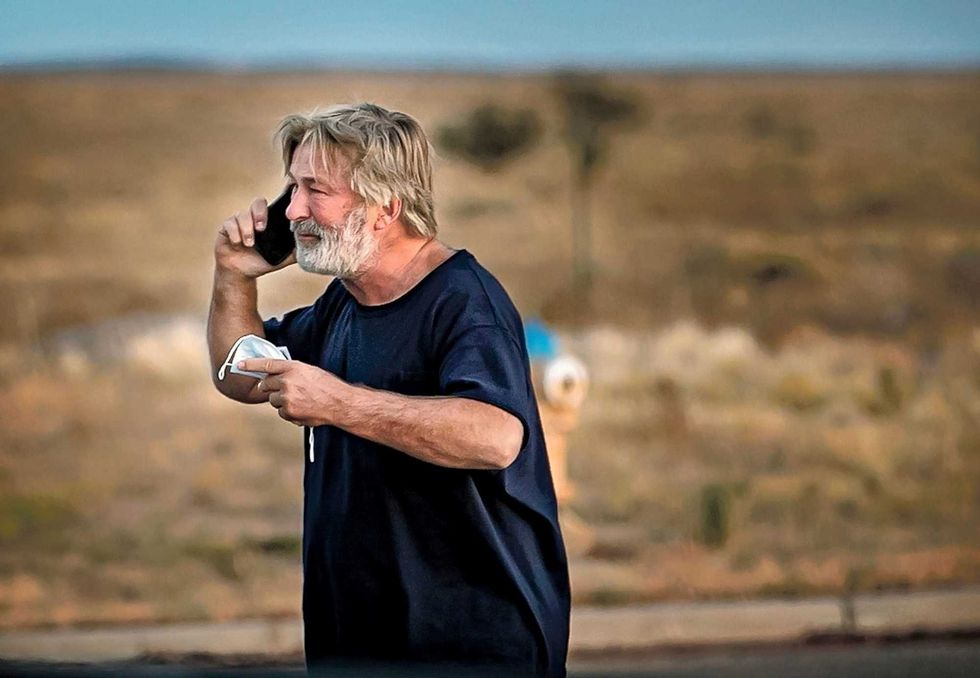 Alec Baldwin speaks on the phone in the parking lot outside the Santa Fe County Sheriff