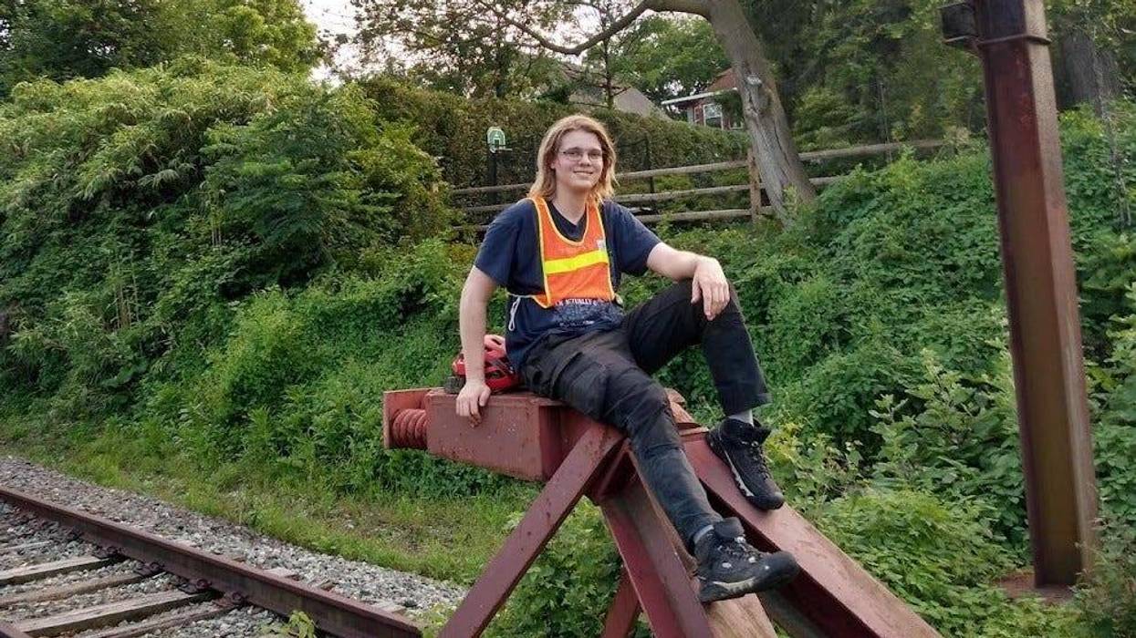 Alex Davis sitting atop the bumper post of SEPTA's currently suspended Cynwyd Line.