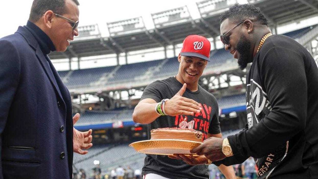 Alex Rodriguez and David Ortiz give Washington Nationals' Juan Soto a cake for his 21st birthday before Game 3 of the baseball World Series against the Houston Astros Friday, Oct. 25, 2019, in Washington.
