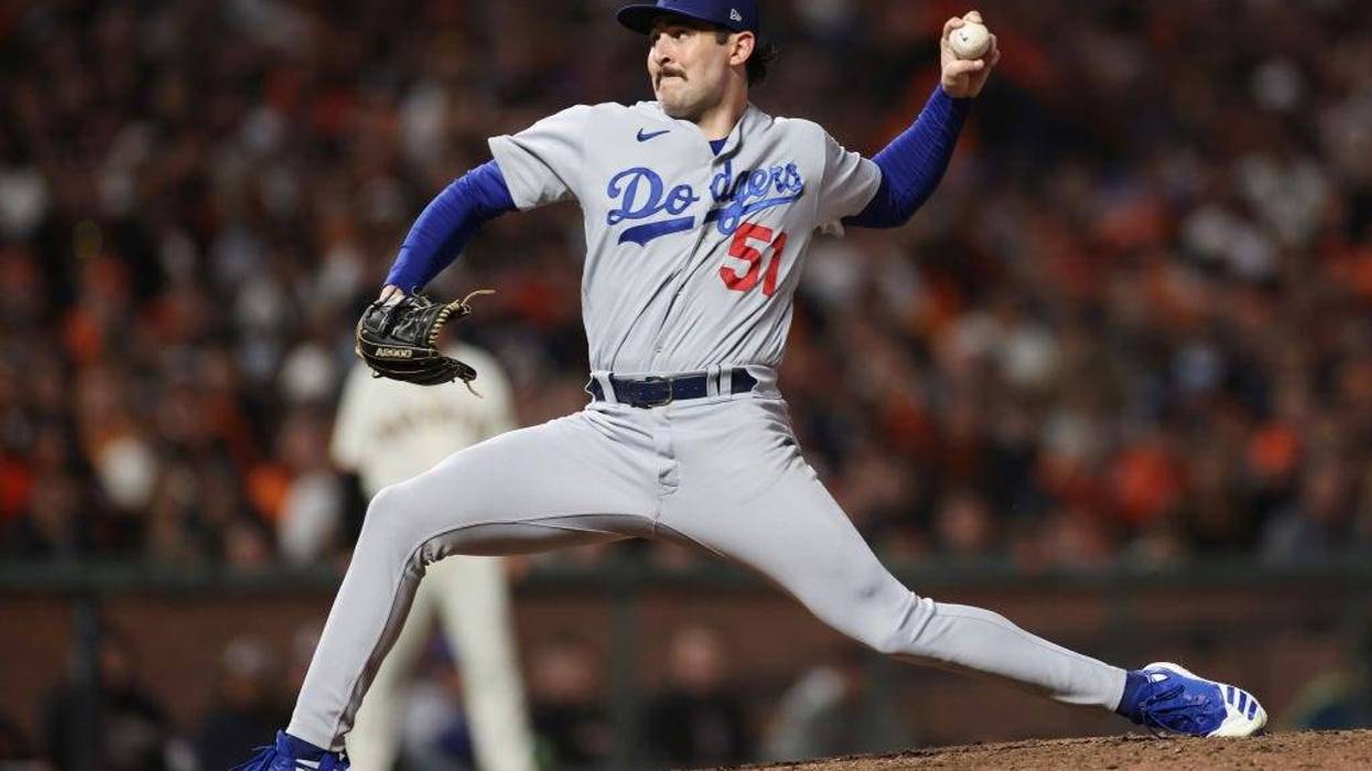 Alex Vesia #51 of the Los Angeles Dodgers delivers a pitch against the San Francisco Giants during the eighth inning of Game 1 of the National League Division Series..