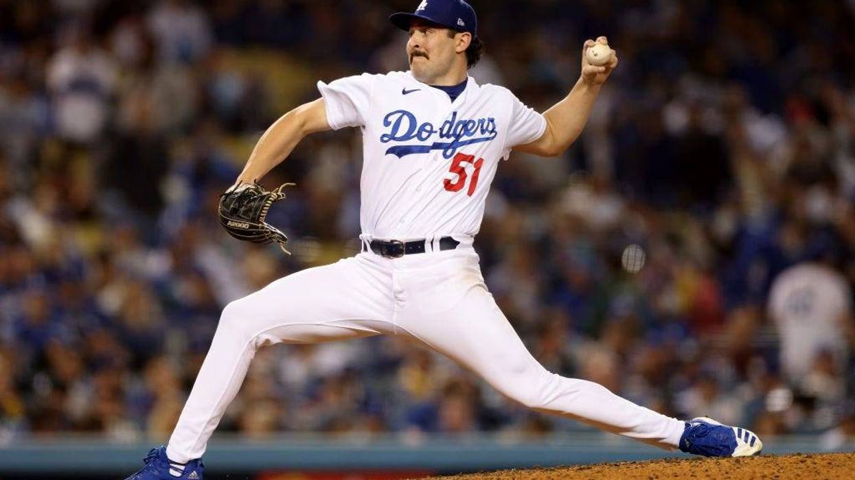 Alex Vesia #51 of the Los Angeles Dodgers pitches against the San Francisco Giants during the seventh inning.