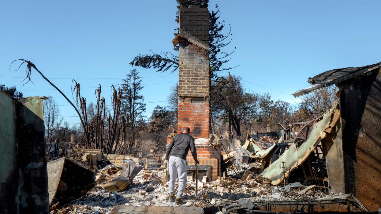ALTADENA, CALIFORNIA - JANUARY 21: Steve Hudson sifts through what remains of his living room on January 21, 2025 in Altadena, California. Multiple wildfires which were fueled by intense Santa Ana Winds have burned across Los Angeles County leaving at least 27 dead with over 180,000 people having been under evacuation orders or warning. Over 14,000 structures have burned in the Palisades and Eaton Fires, with Santa Ana Winds fueling new fires. President Donald Trump plans to visit California on Friday to survey the damage.