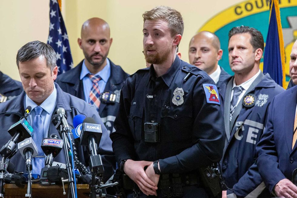 Altoona Police officer Tyler Frye, center, speaks during a press conference regarding the arrest of suspect Luigi Mangione, Monday, Dec. 9, 2024, in Hollidaysburg, Pa
