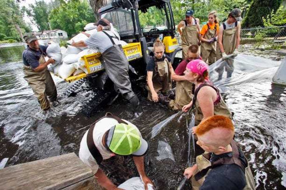Always ready with a helping hand, Waterville residents sandbag homes along the shoreline of Lake Tetonka where homes are being flooded as a result of recent heavy rains in 2014.